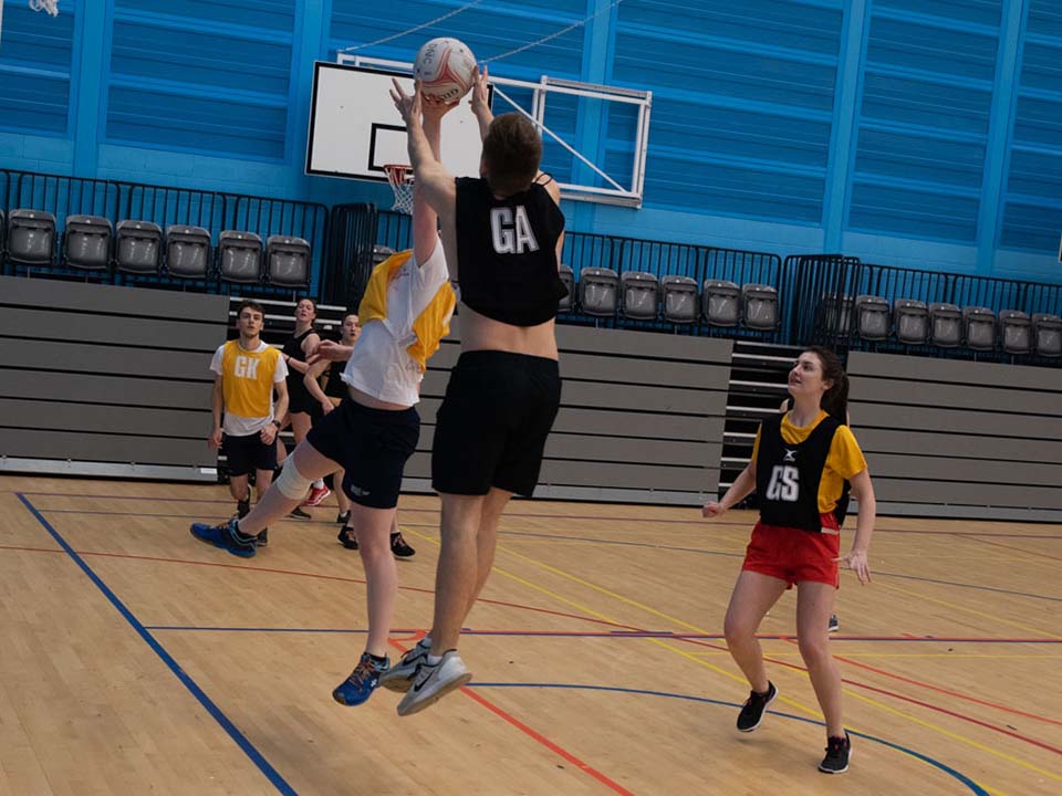 A group of students playing netball at the Oriam